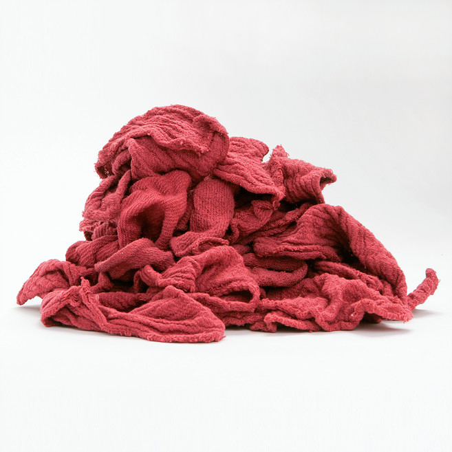 Red color crushed clothes on white background